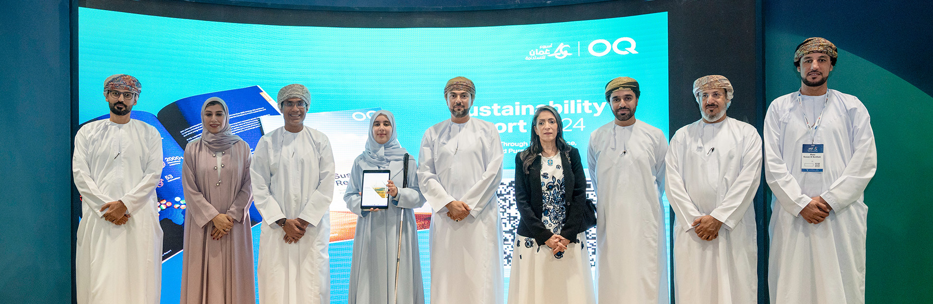 Image of people standing in front of a presentation screen